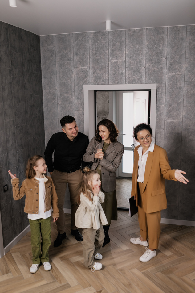 Real Estate Agent Showing a Family an Apartment 